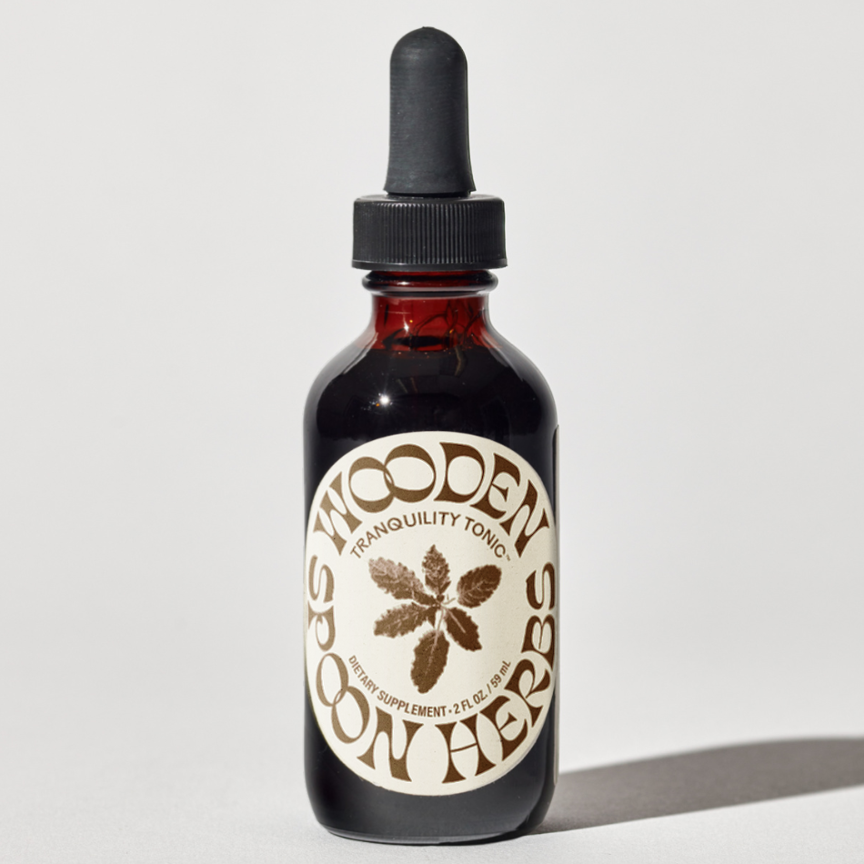Bottle of Wooden Spoon Herbs Tranquility Tonic on a light gray background