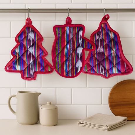 Colorful patterned pot holders hanging on a rack with kitchen items below.