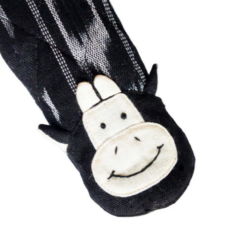 Black and white striped fabric with a smiling cow face design on a white background