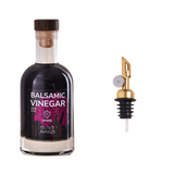 Balsamic vinegar bottle with a cork stopper and a gold-colored pour spout on a white background.