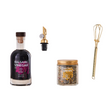 Balsamic vinegar bottle, spice jar, and whisk on a white background