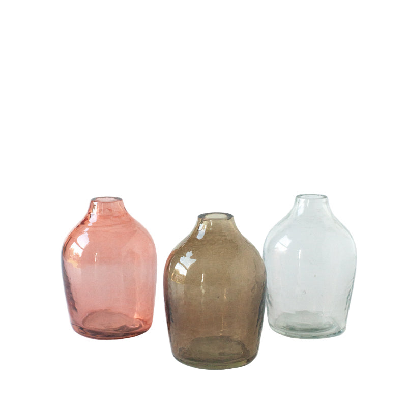 Three glass vases of different colors on a white background
