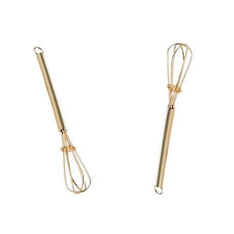 Two gold whisks on a white background