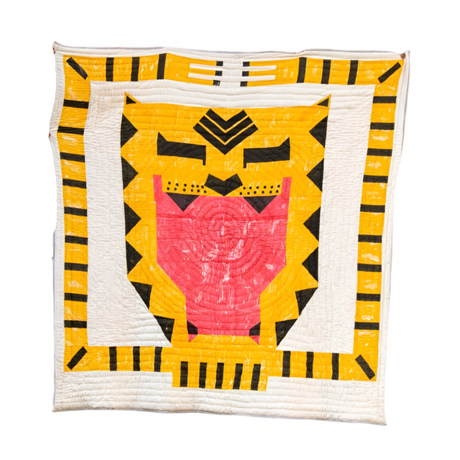 Colorful quilt with a geometric design on a white background