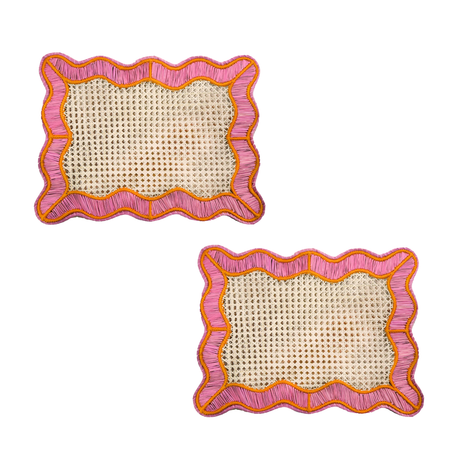 Two square woven placemats with pink and orange scalloped edges on a white background.