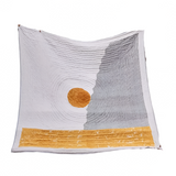Textile with a sun and mountain design on a white background