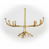 A gold menorah shaped like a stylized tree trunk with branching arms, shown against a plain white background.