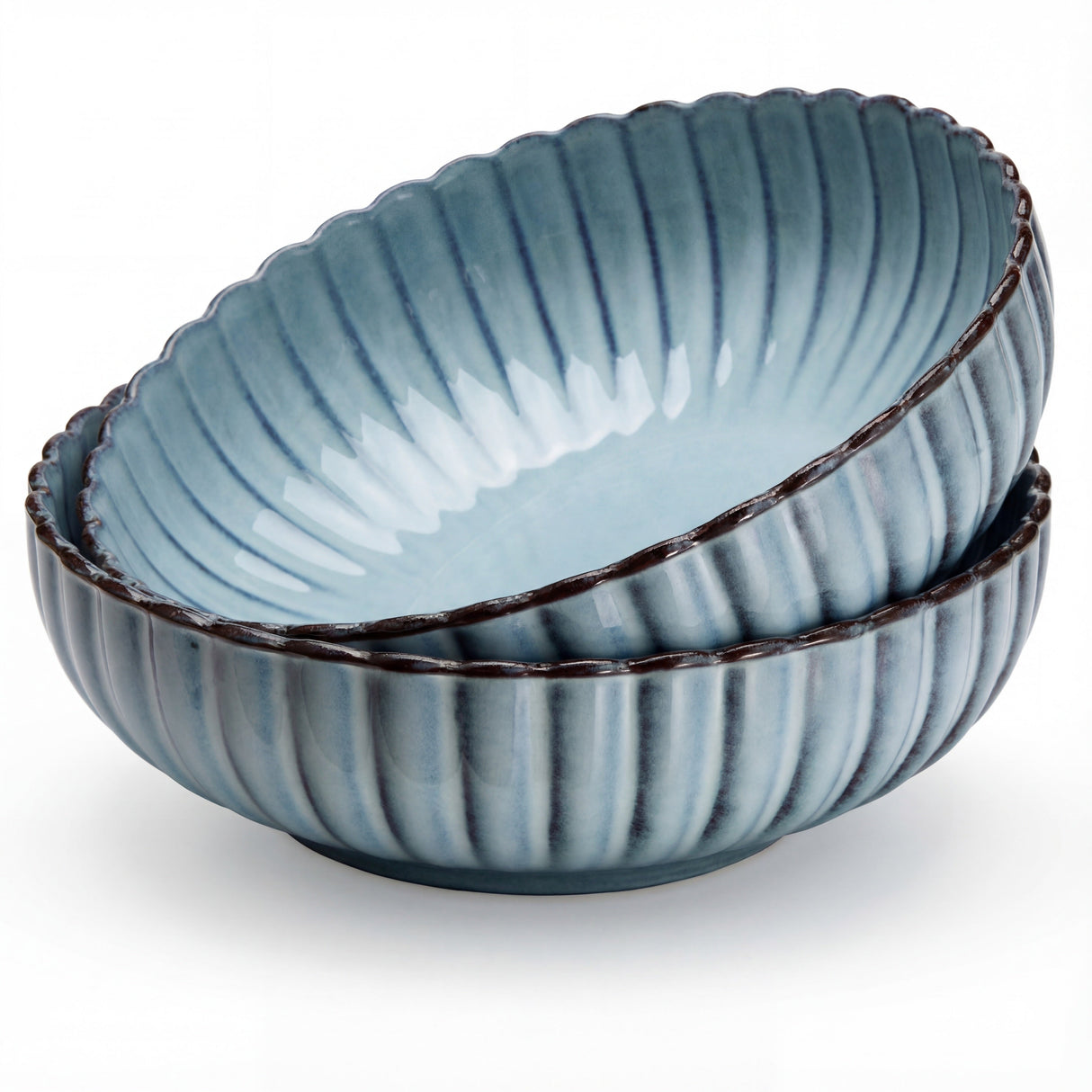Set of three blue ceramic bowls with ribbed texture on a white background