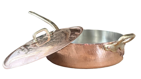 Copper frying pan with lid on a white background
