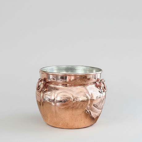 Copper jar with handles on a white background