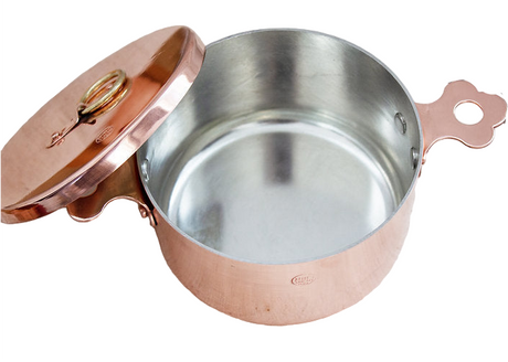 Copper pot with a lid on a white background