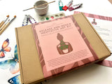 Meditative art kit packaging with tools and butterfly decorations on a white surface