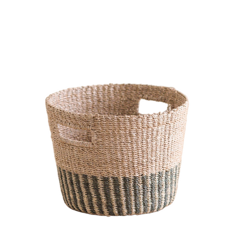 Woven basket with natural and black striped design on a white background