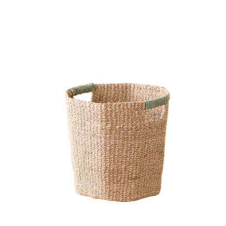 Woven basket with green handles on a white background