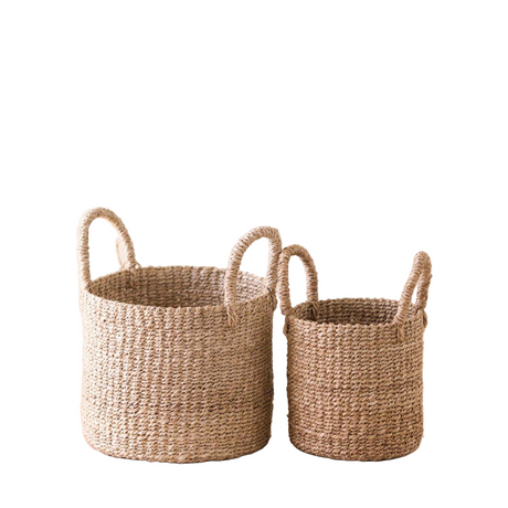 Two woven baskets with handles on a white background