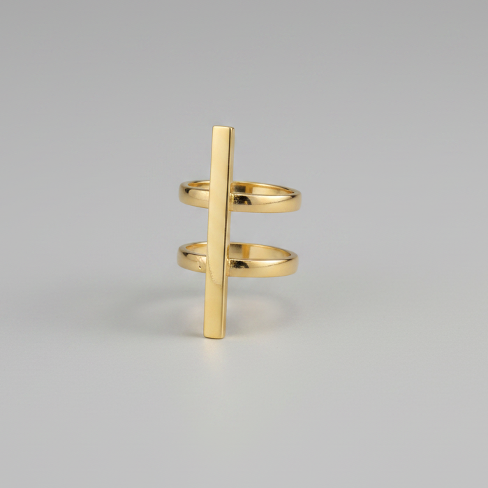 Gold ring with a vertical bar design on a gray background