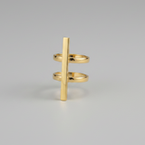Gold ring with a vertical bar design on a gray background