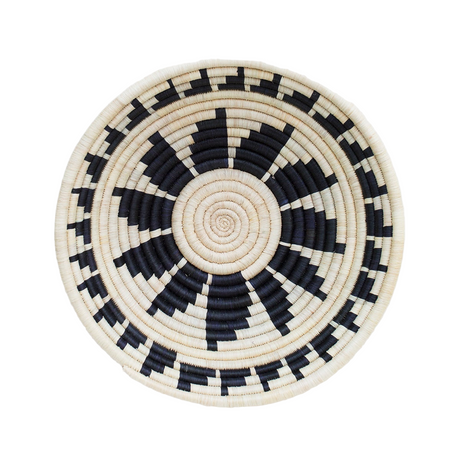 Round woven basket with black and beige pattern on a white background