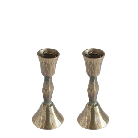 Two metallic candle holders on a white background