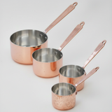 Set of copper cookware with handles on a white background