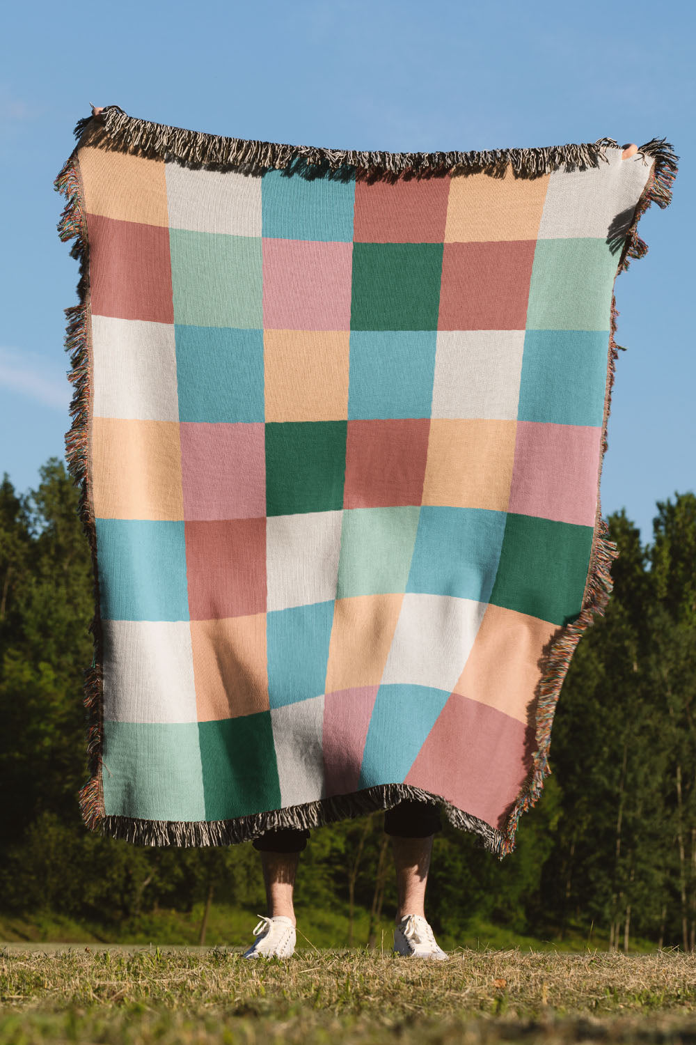 Plaid-inspired cotton woven throw blanket featuring a modern checkered pattern.
