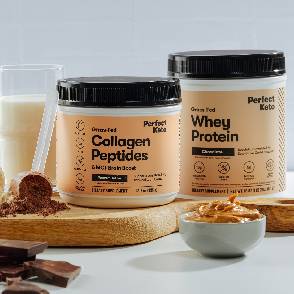 Two containers of Perfect Keto products on a white surface with a wooden board and bowl.