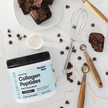 Collagen peptides container with brownies and chocolate chips on a marble surface