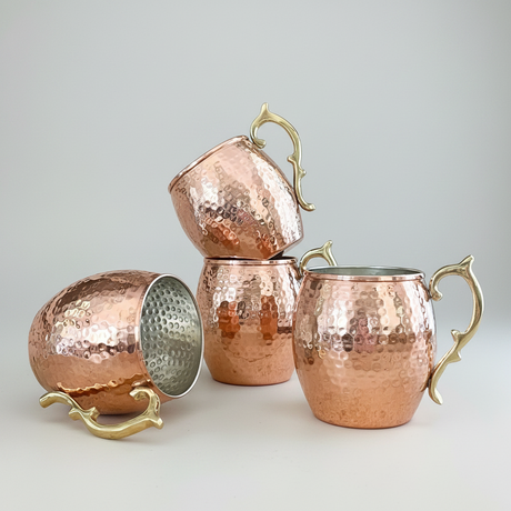Set of copper mugs with handles on a white background