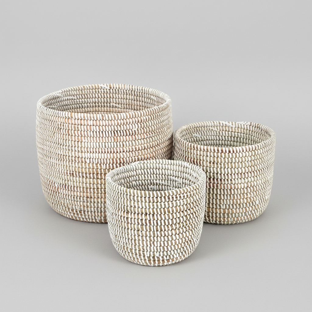 Three woven baskets of different sizes on a white background