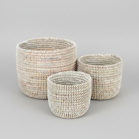 Three woven baskets of different sizes on a white background
