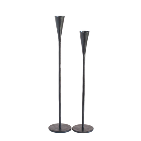 Two black metal candle holders on a white background