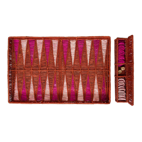 Backgammon set with pink and brown pieces on a white background