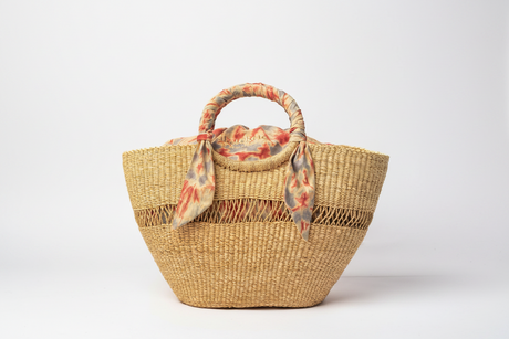 Woven basket with a floral scarf on a white background