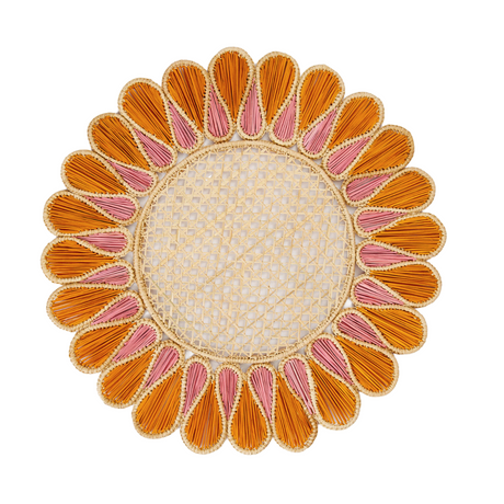 Decorative round placemat with orange and pink petal-like patterns on a white background