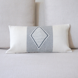 Decorative pillow with geometric pattern on a light gray sofa
