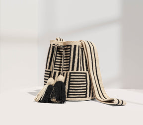 Woven bag with black and white pattern on a light gray background