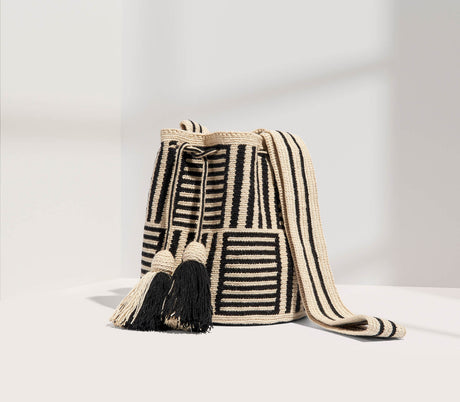 Woven bag with black and white pattern on a light gray background