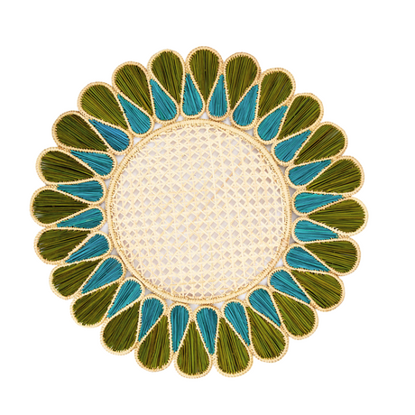 Decorative round mat with green and blue leaf-like patterns on a white background