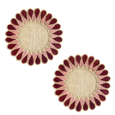 Pair of sunflower-shaped placemats with red and pink petals on a white background