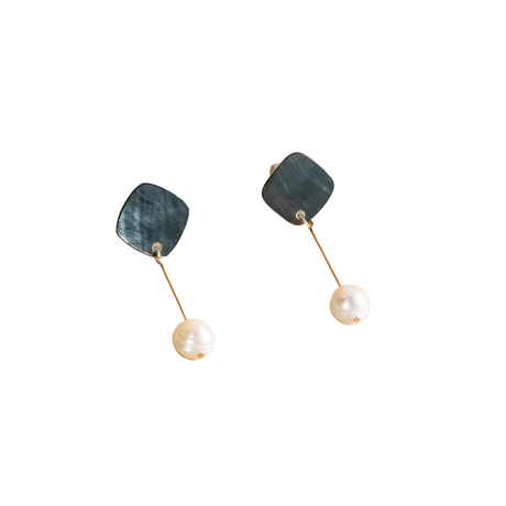 Pair of earrings with green stone and pearl on a white background