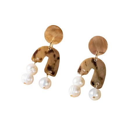 Pair of gold and pearl earrings on a white background