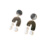 Pair of earrings with geometric designs and pearl-like beads on a white background
