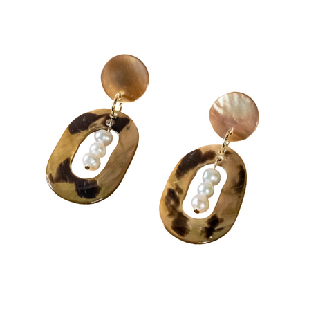 Pair of earrings with tortoiseshell design and pearl-like beads on a white background