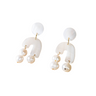 Pair of earrings with white arches and pearl-like beads on a white background