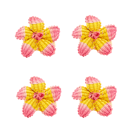Four pink and yellow hibiscus napkin rings on a white background
