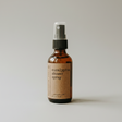 Brown glass bottle of eucalyptus shower spray on a white background