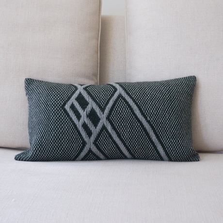 Decorative pillow with geometric pattern on a beige sofa