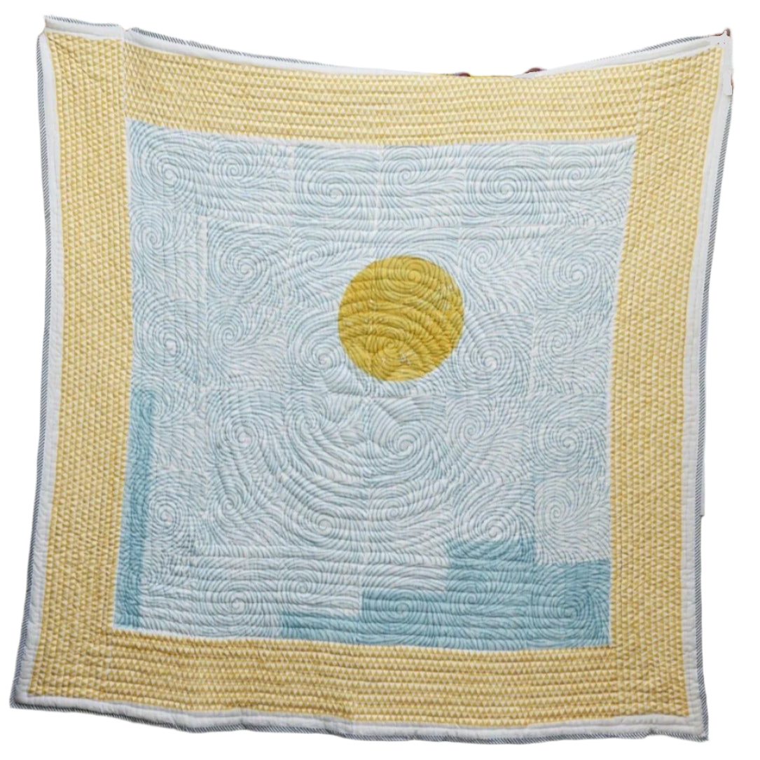 Quilt with a yellow circle and blue pattern on a white background