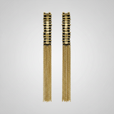 Pair of gold tassel earrings on a light gray background