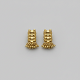 Pair of gold earrings on a gray background